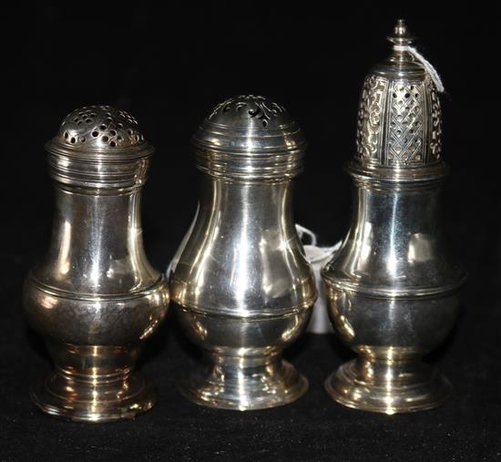 Two George II silver bun-topped peppers, London 1727 and 1757 and a small sugar caster of baluster form (marks rubbed).